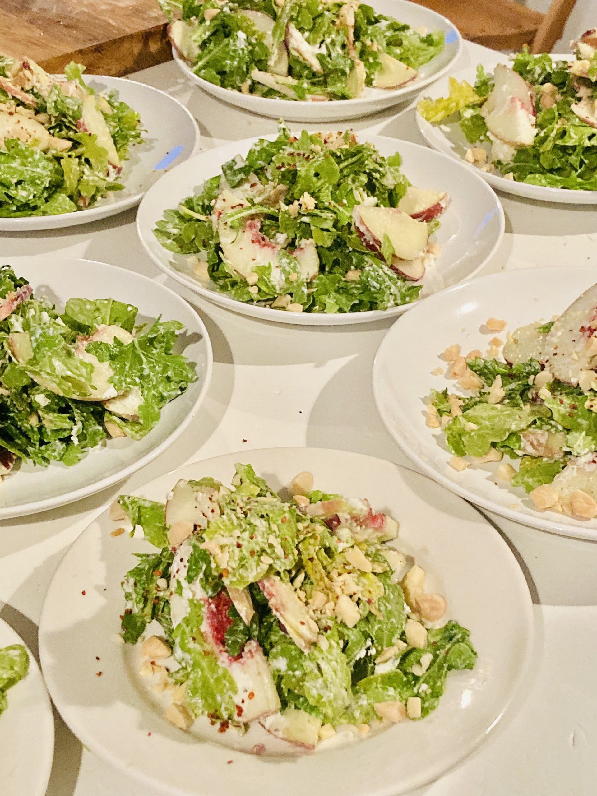 A table topped with plates of salads