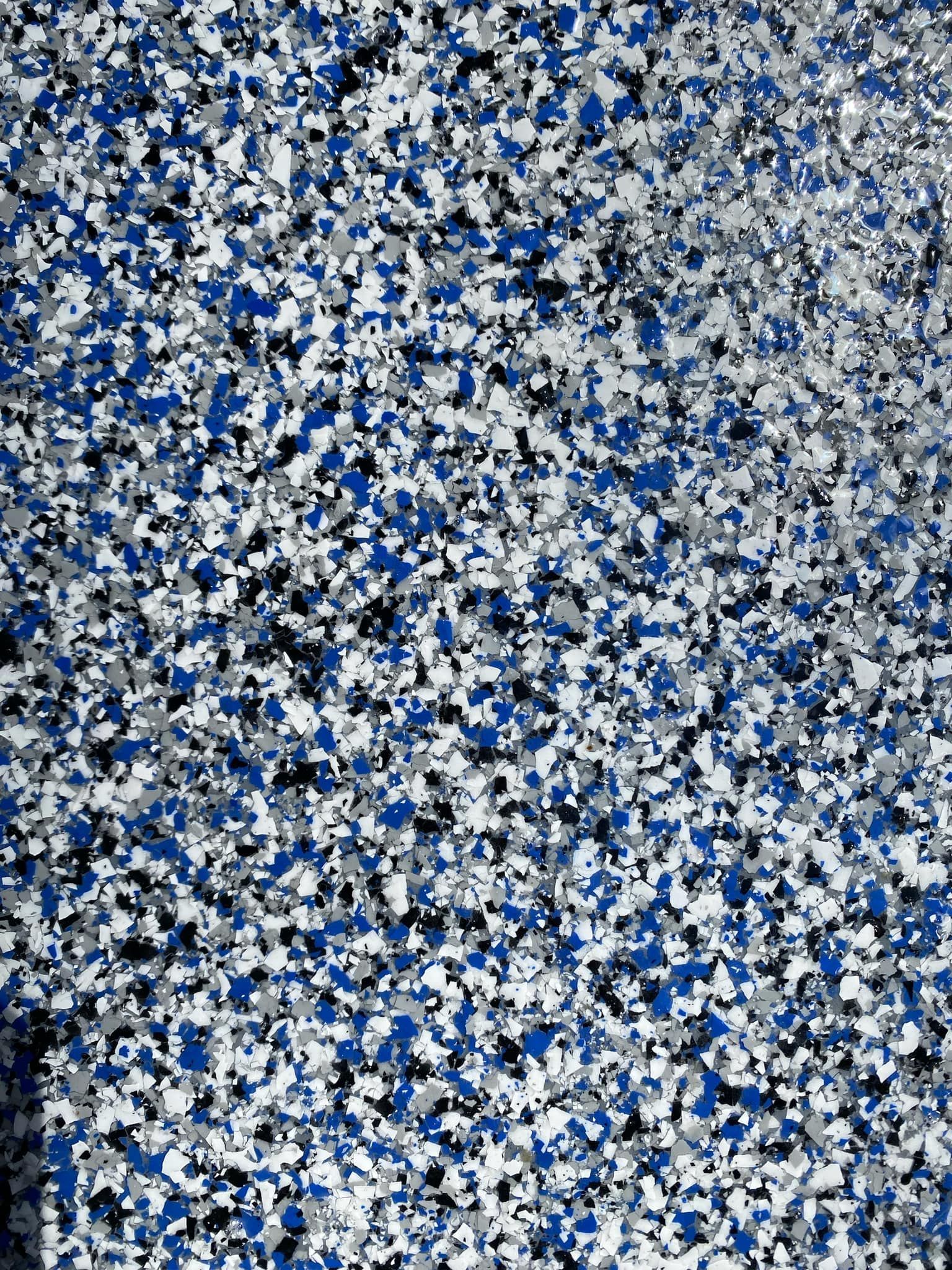 Blue, white, and black confetti-like abstract pattern filling the frame
