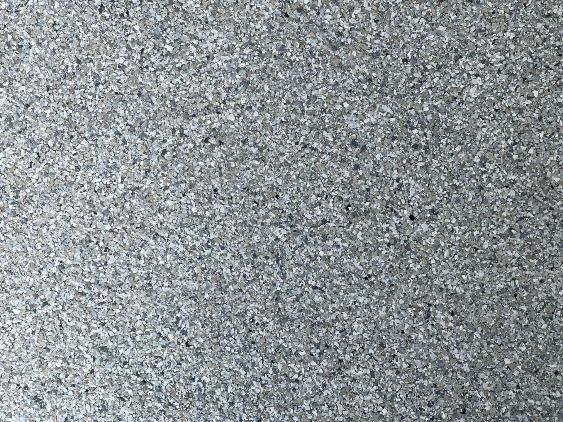 Gray speckled textured surface with a subtle light-to-dark gradient