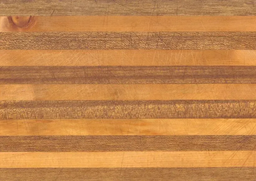 Wooden cutting board with alternating light and dark brown stripes