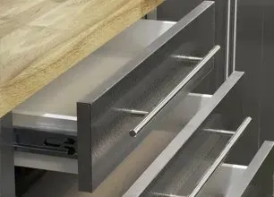 Open drawer with stainless steel cutlery tray in a modern kitchen cabinet