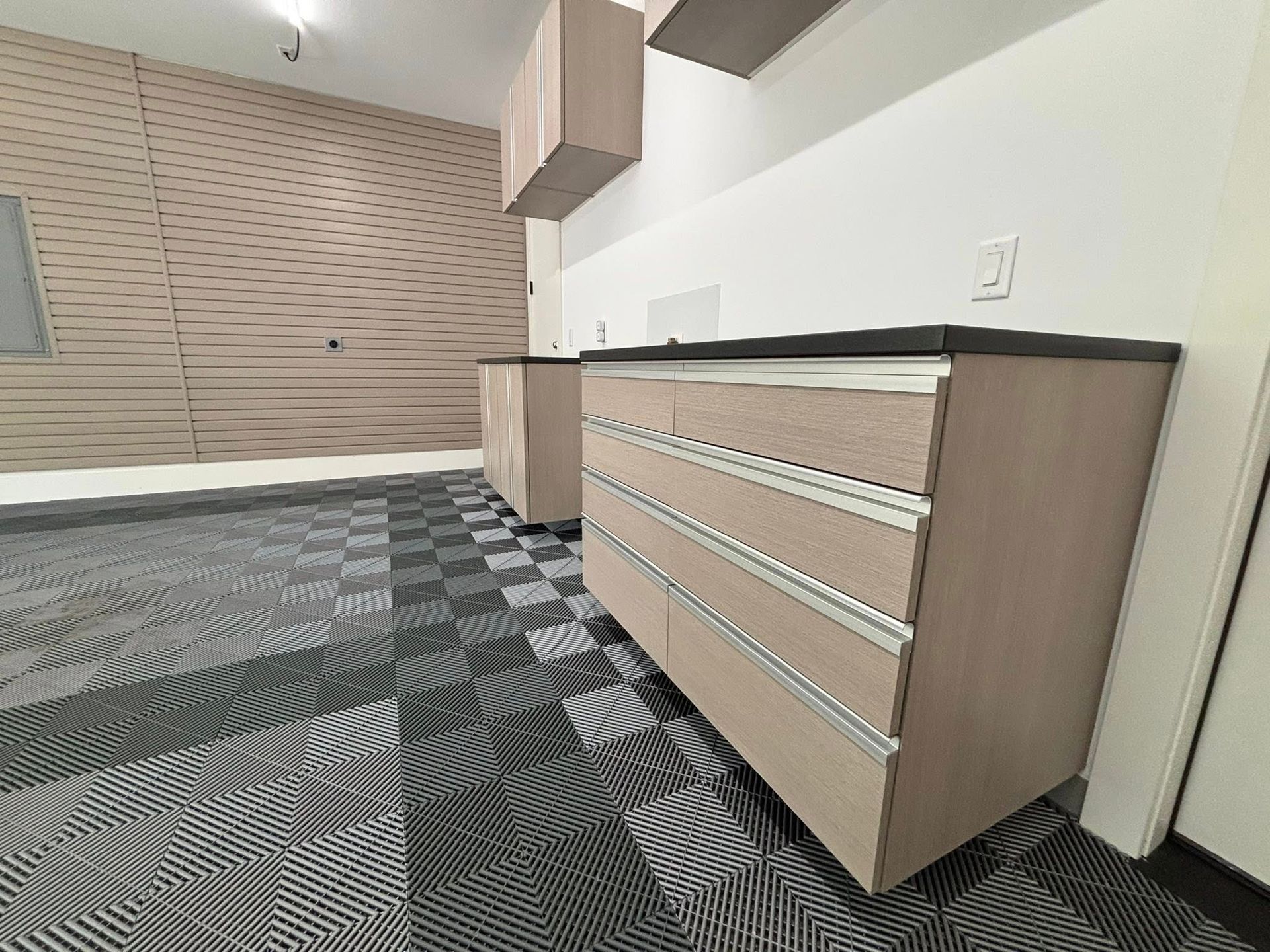 Modern office cabinet with drawers in a carpeted room, with a window and storage wall in the background
