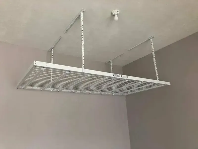 Ceiling-mounted wire storage rack suspended by metal chains in a room