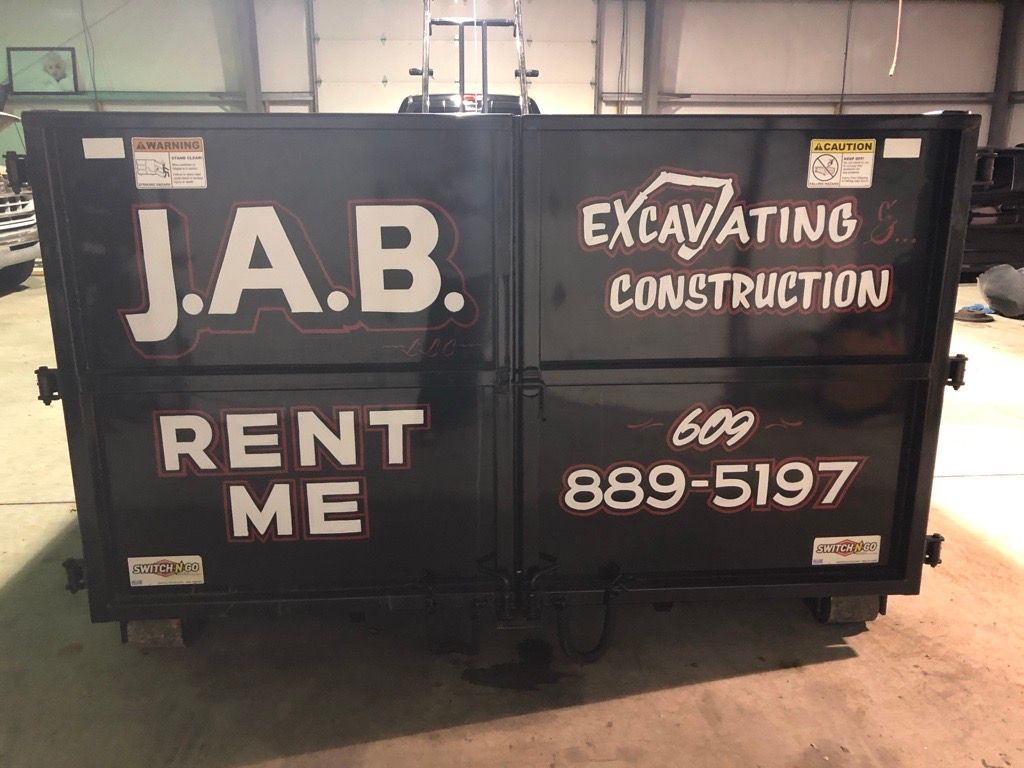 black dumpster with white lettering
