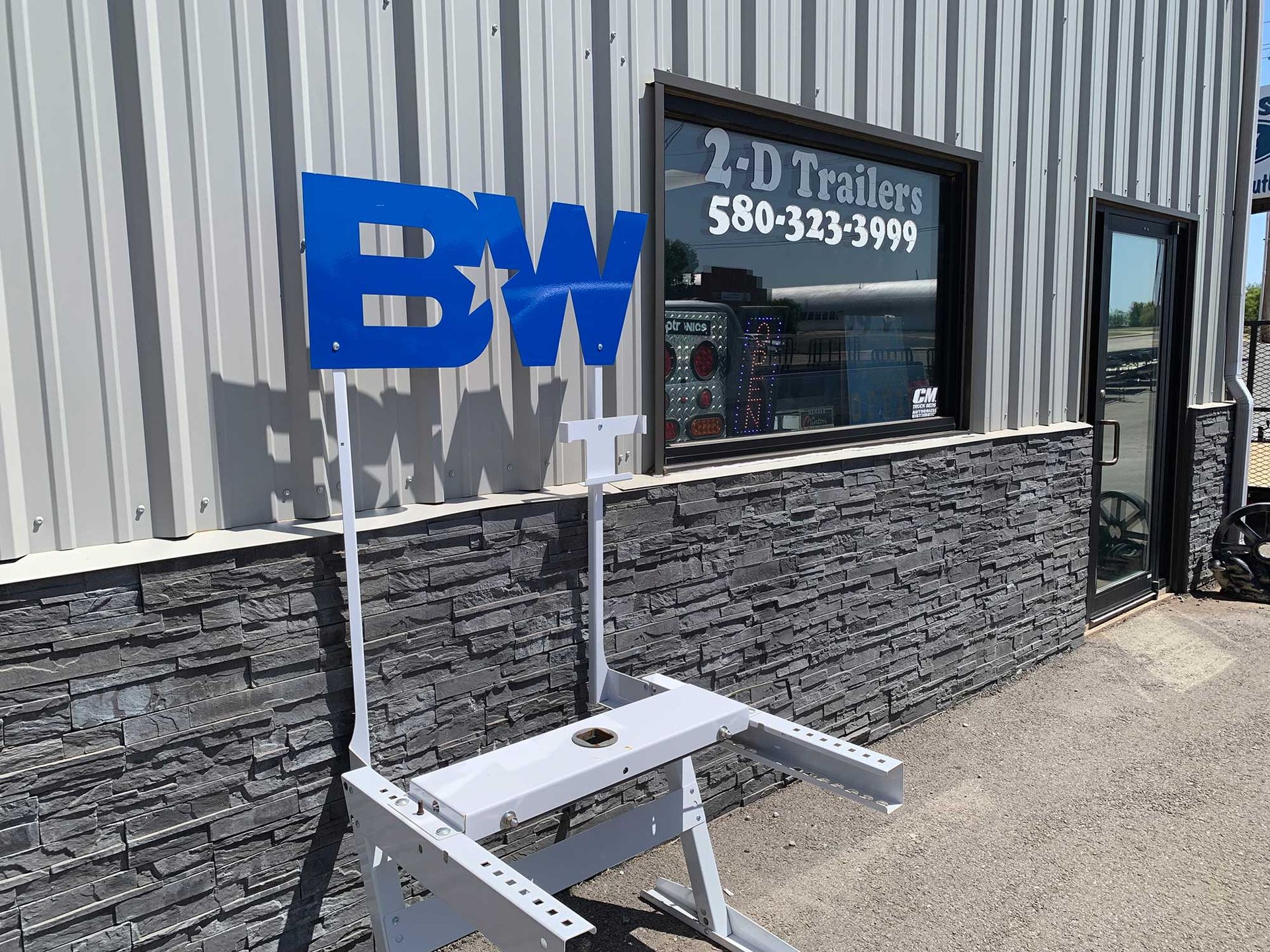 A white picnic table is sitting in front of a building.