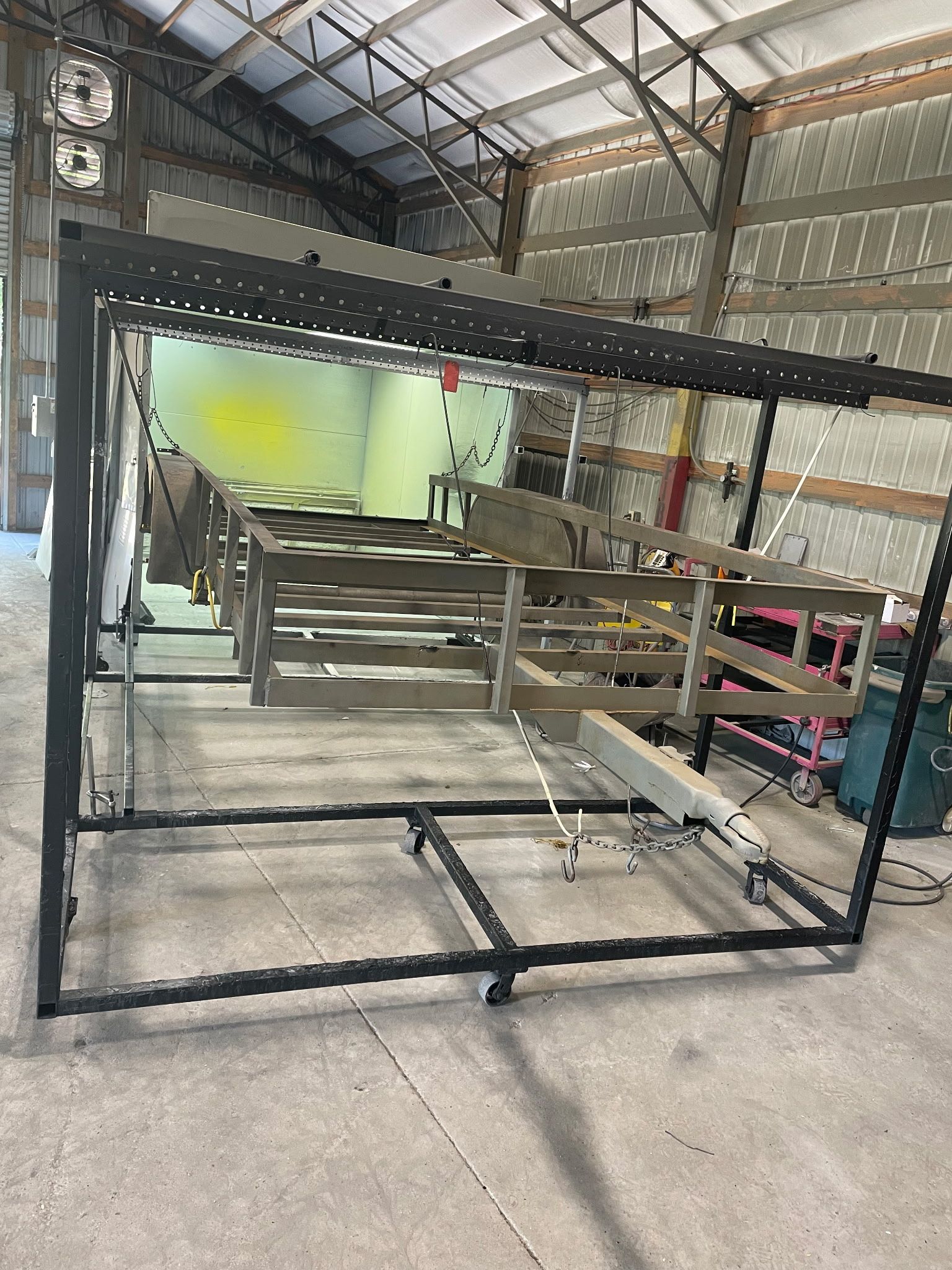 Black and silver metal frame structure inside a barn.