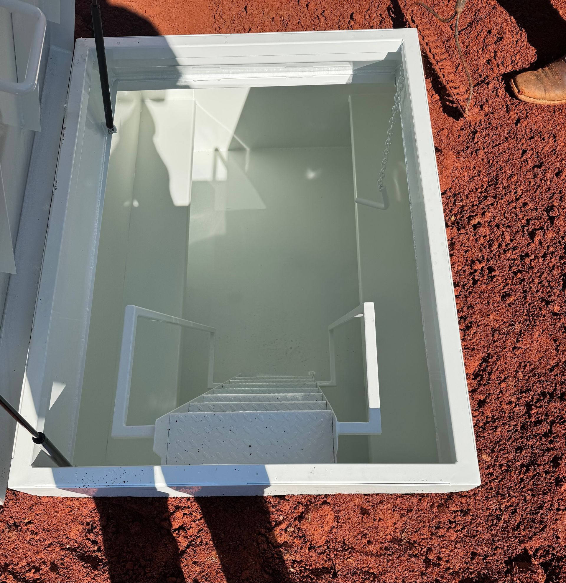 White underground storm shelter.