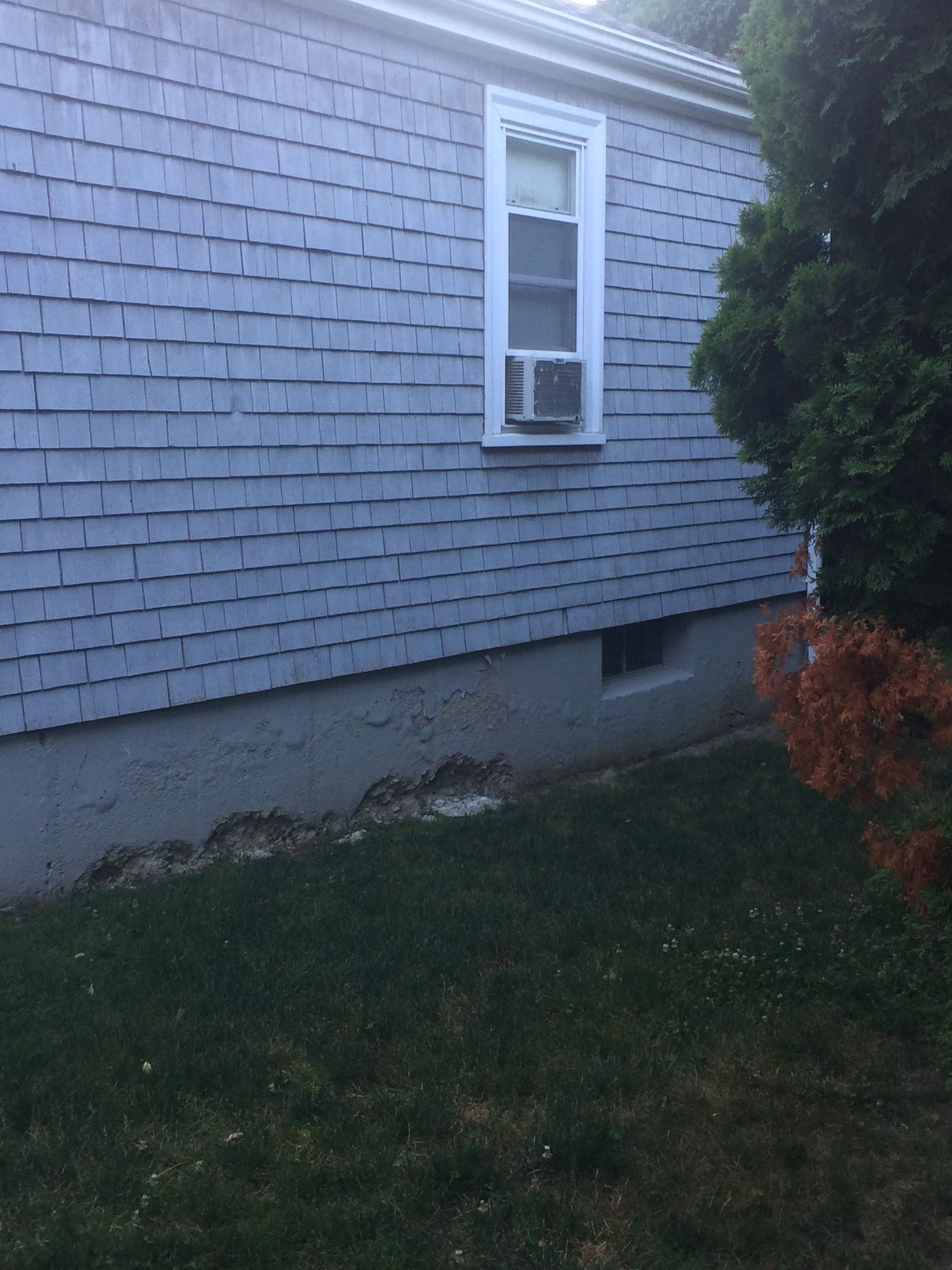 a house with a window and grass