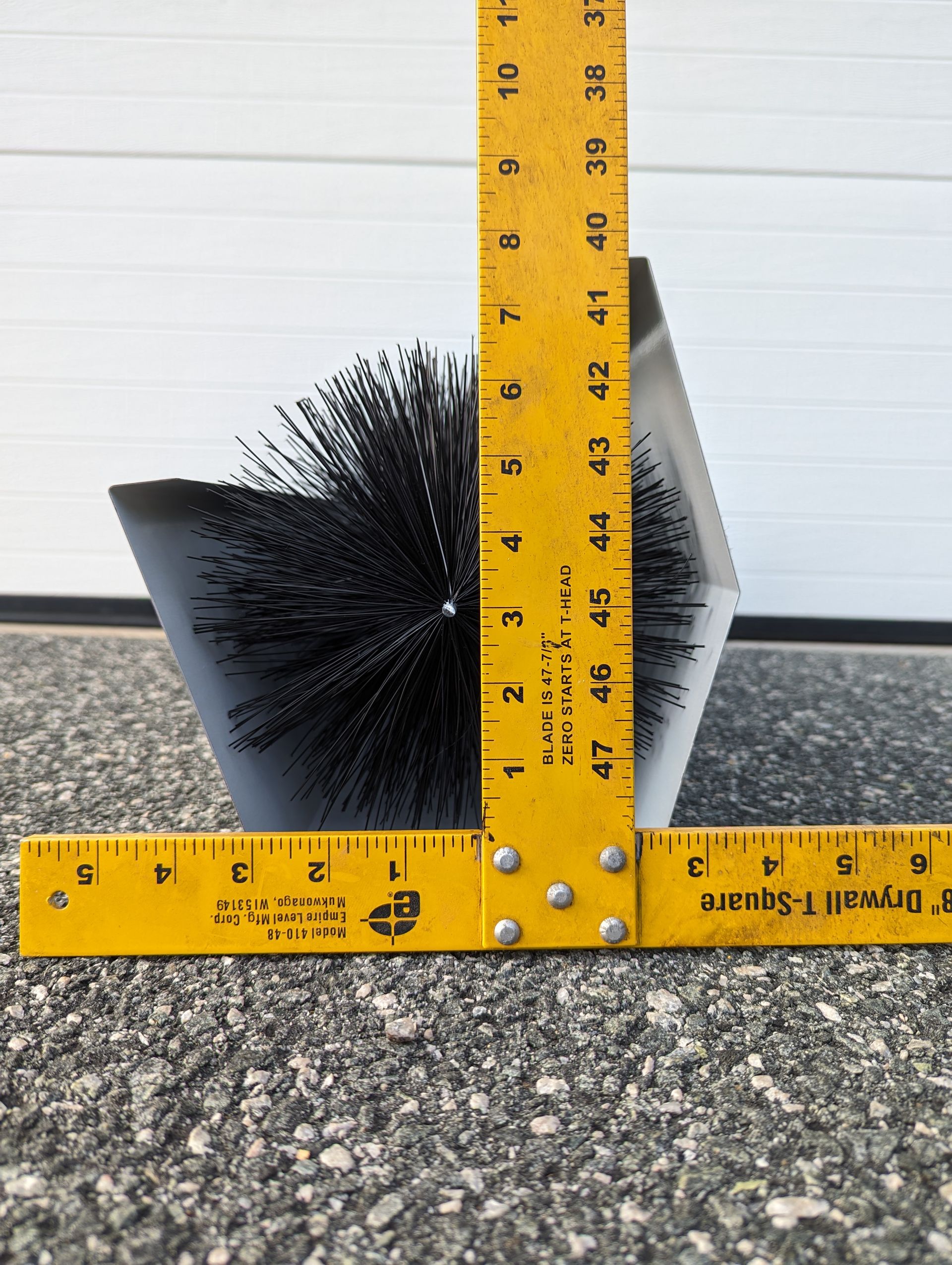 a yellow ruler and gutter brush