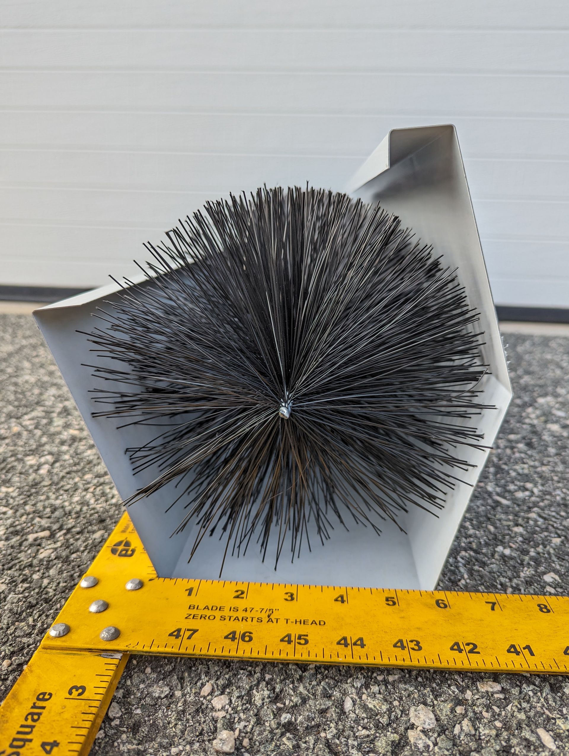 a yellow ruler and gutter brush