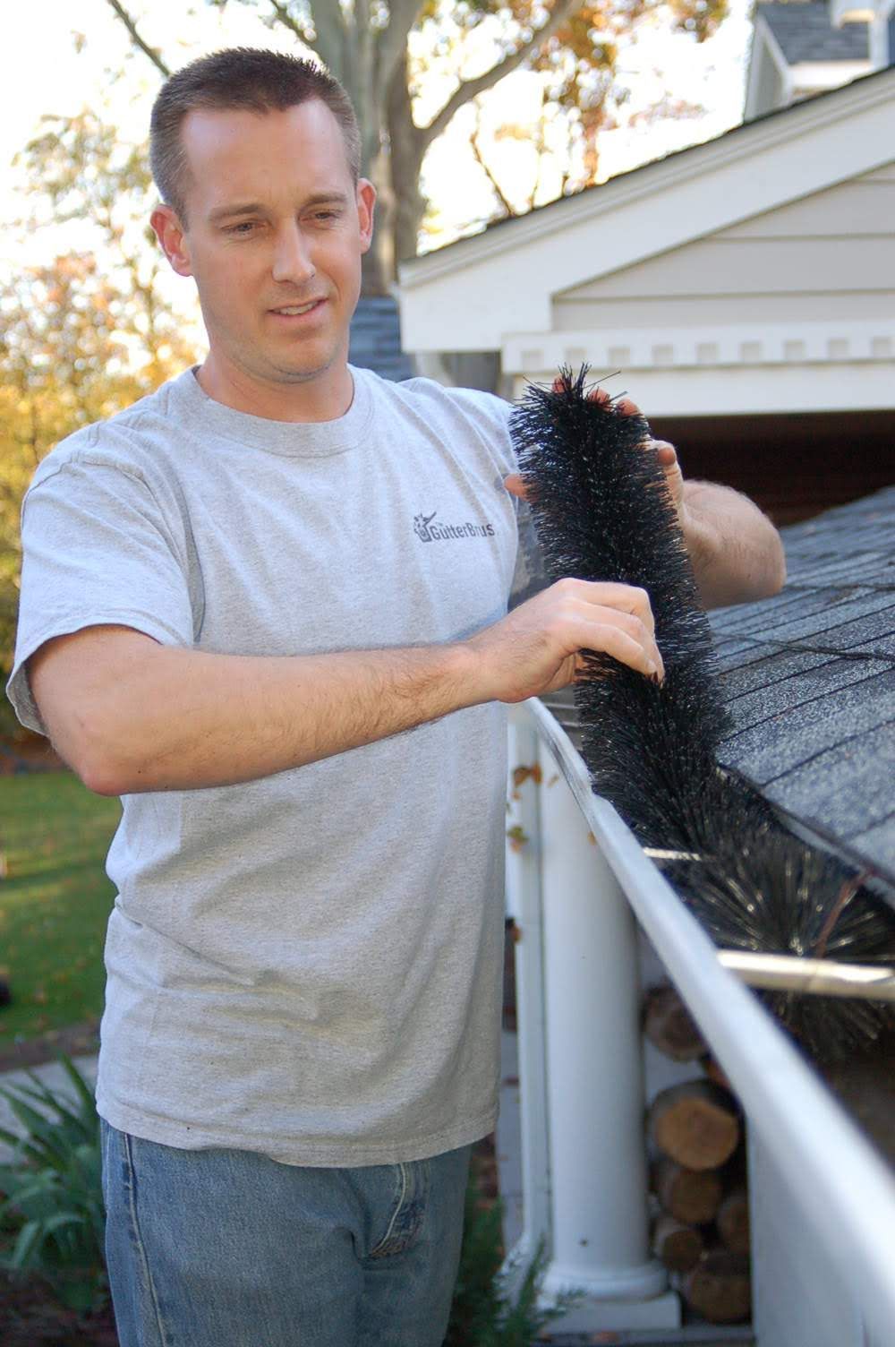 a man holding a brush on a roof