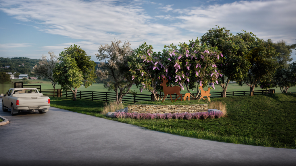 Rural driveway beside a landscaped garden with flowering trees, a pickup truck, and distant hills at sunset
