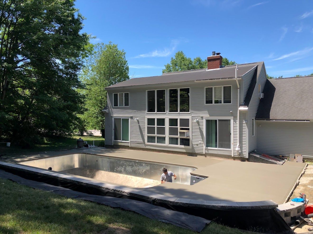 A large house with a swimming pool in front of it.