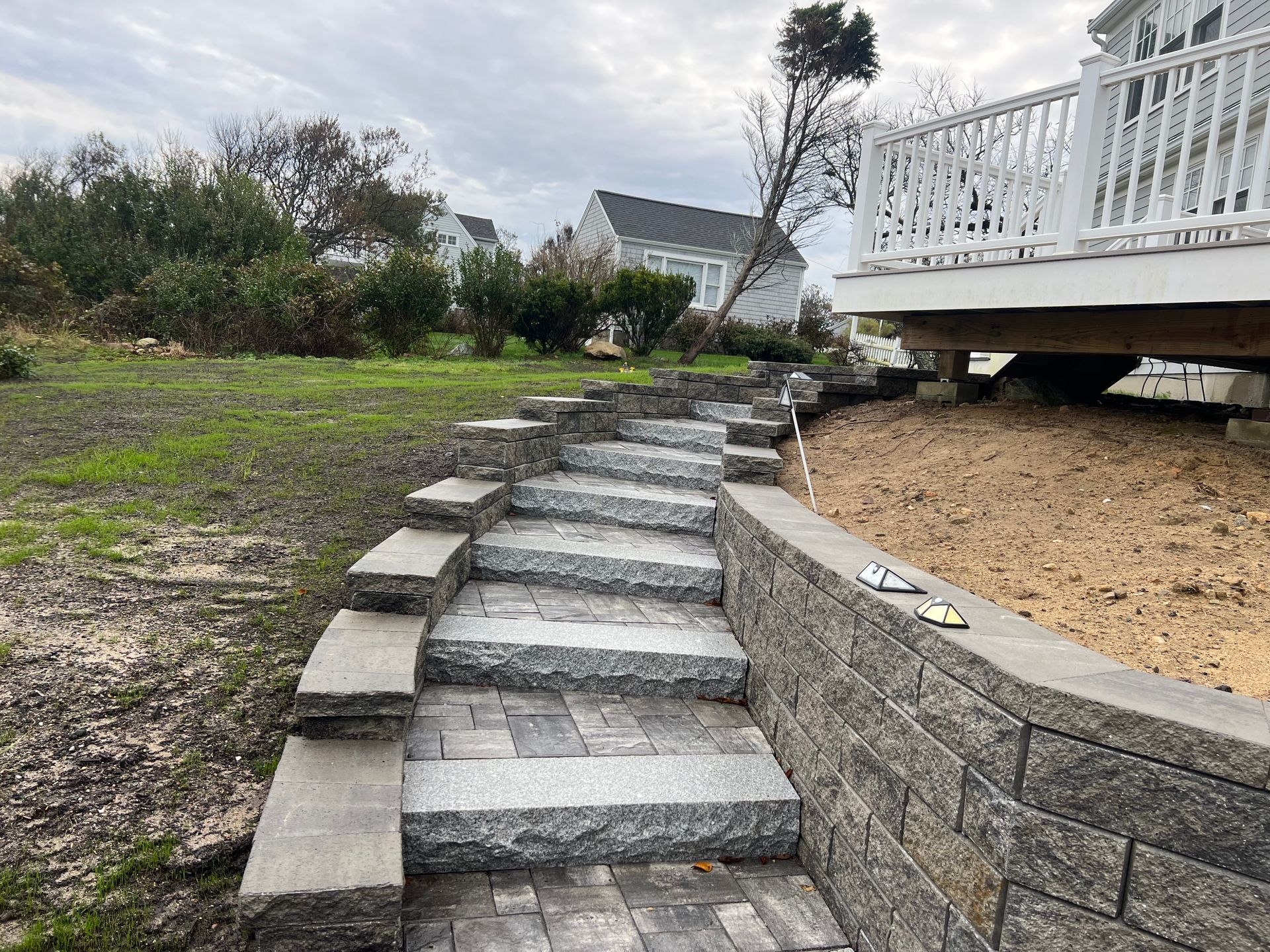 A set of stairs leading up to a deck in a backyard