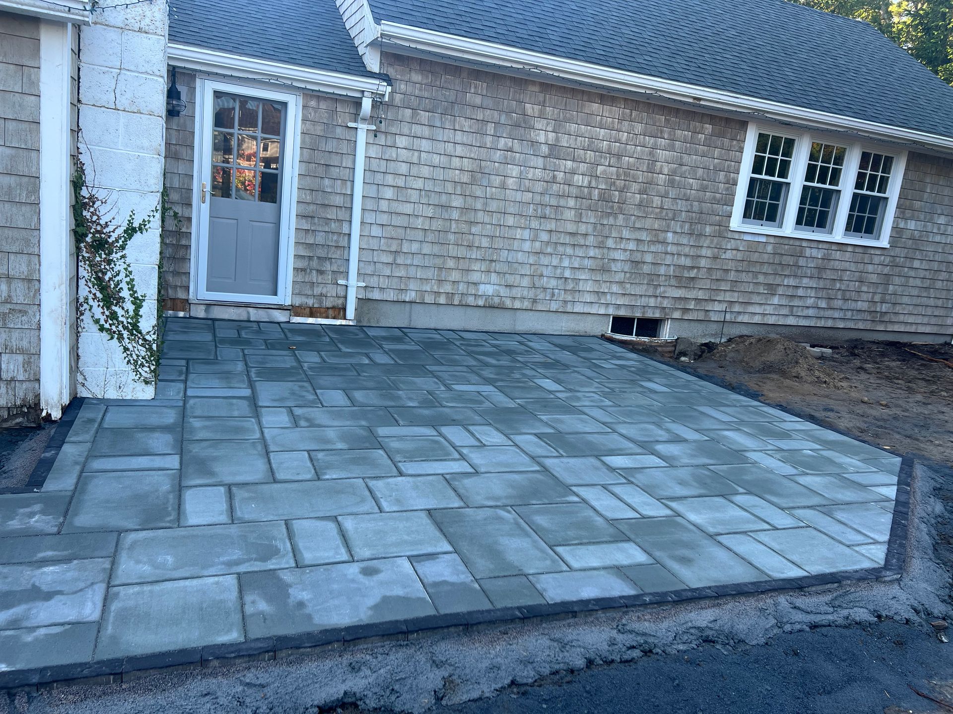 A brick house with a patio in front of it