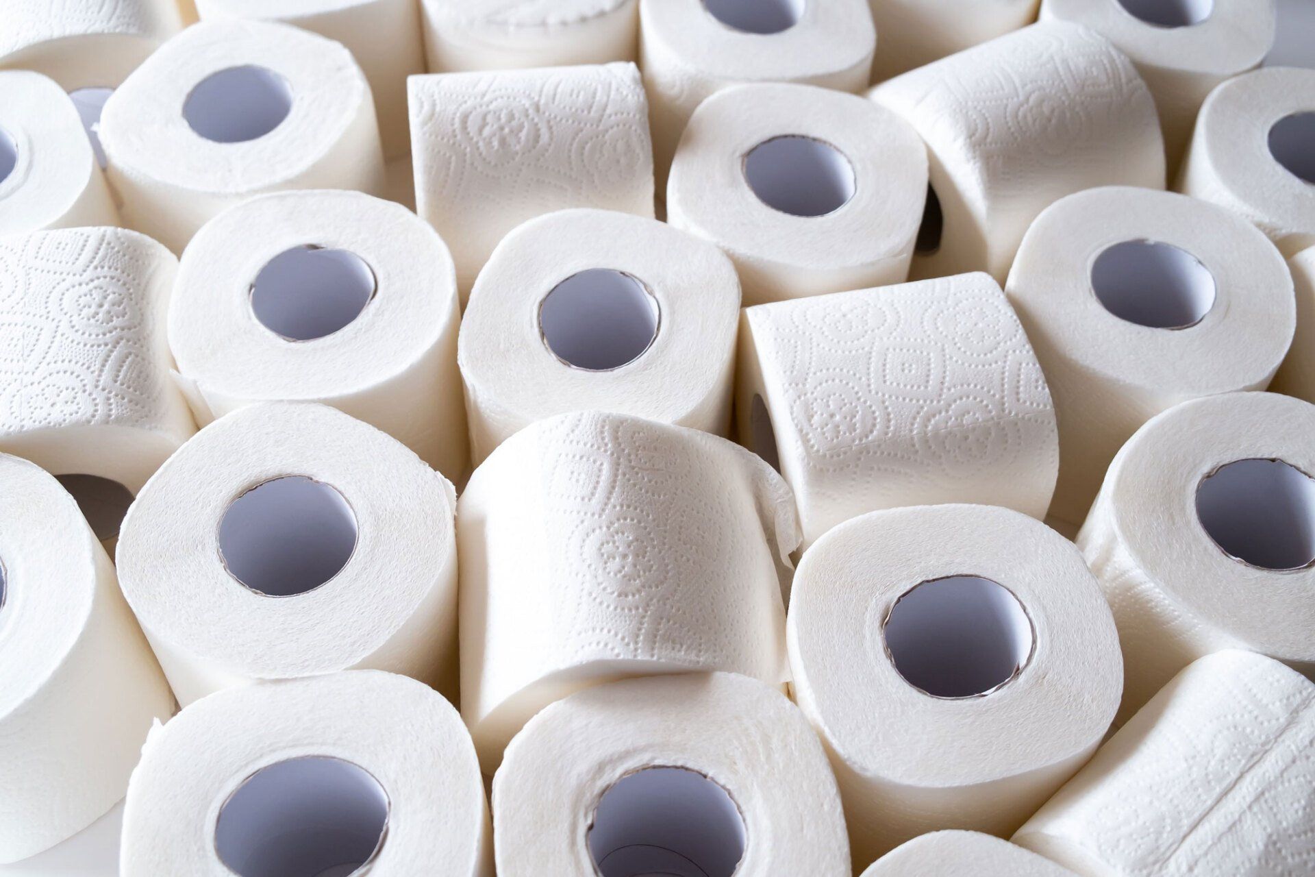 Many rolls of toilet paper are stacked on top of each other