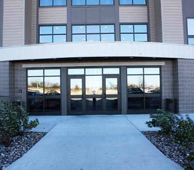 A large building with a concrete walkway leading to it