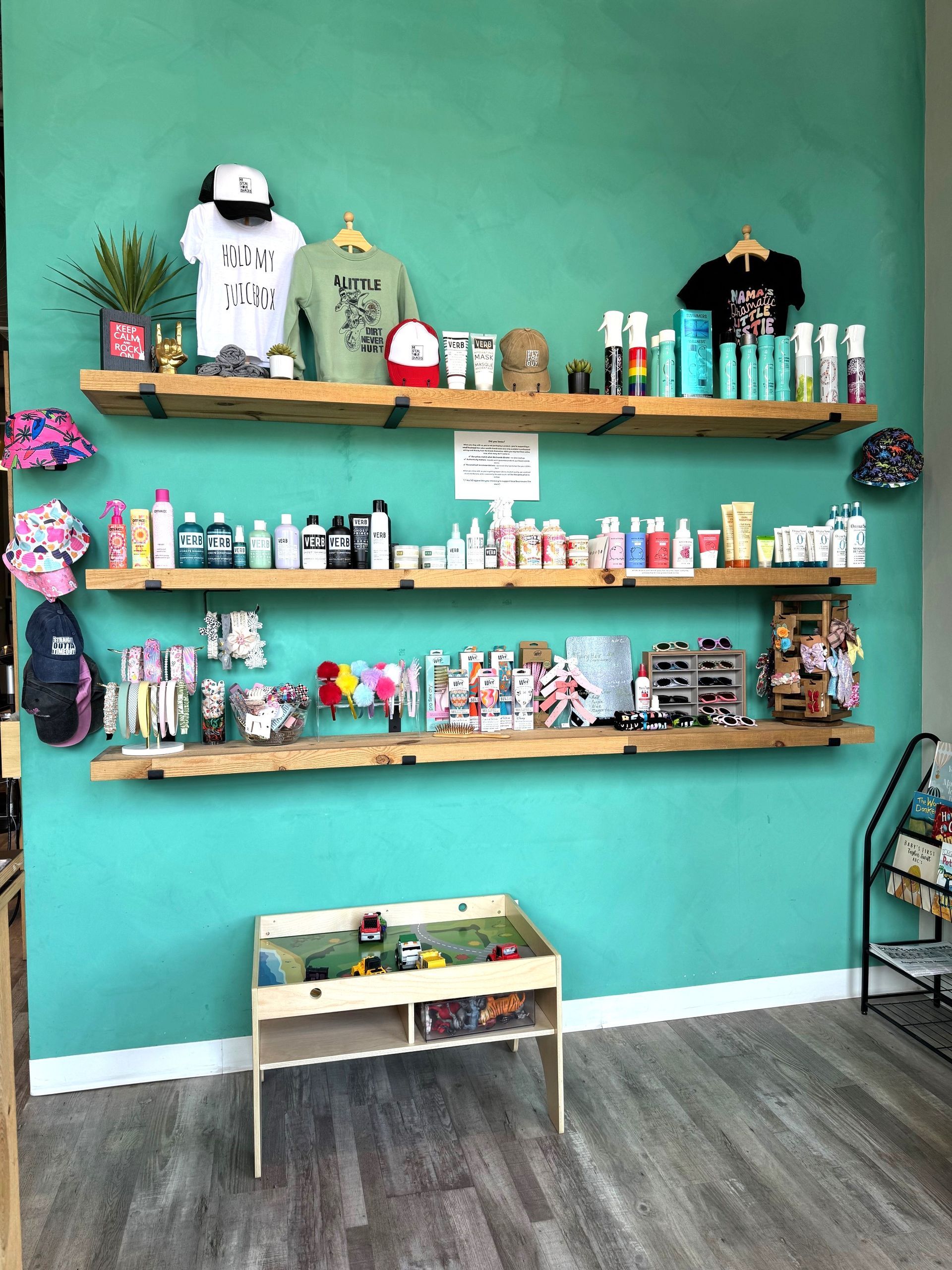 A room with shelves filled with lots of items and a table.
