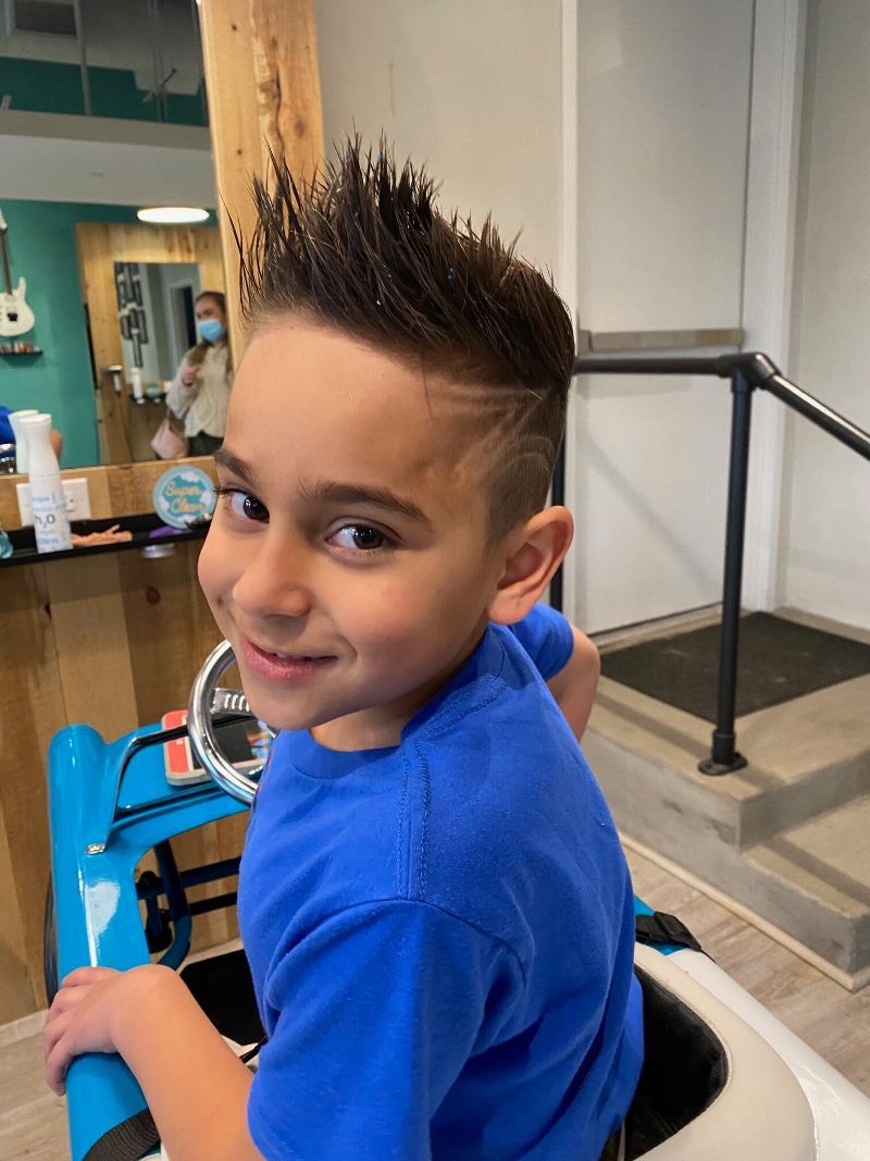 A colorful mural on the wall of a hair salon