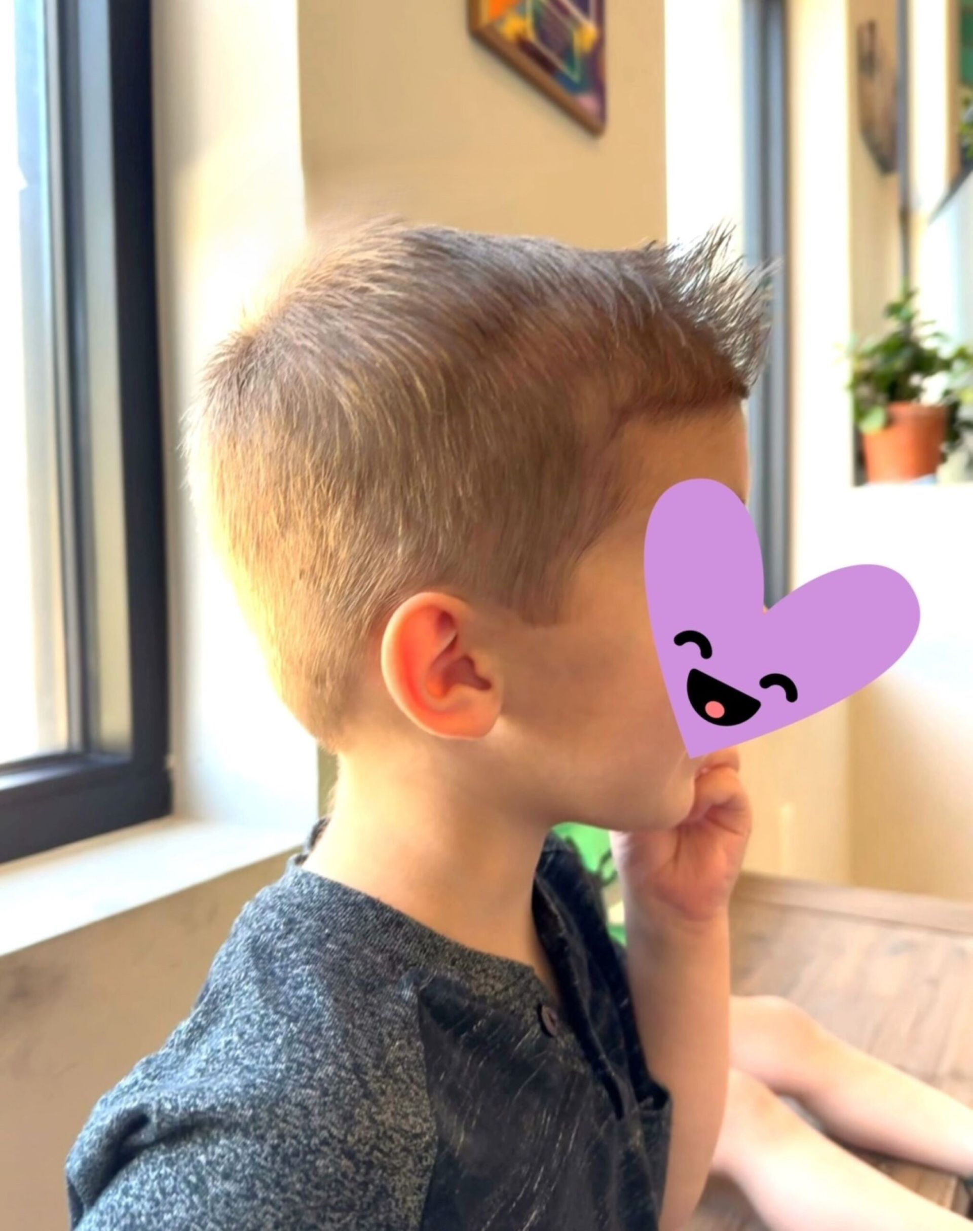 A young boy with a purple heart on his face