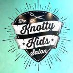 The logo for the knotty kids salon is on a blue wall.