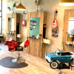 A barber shop with a toy car in the middle of the room.