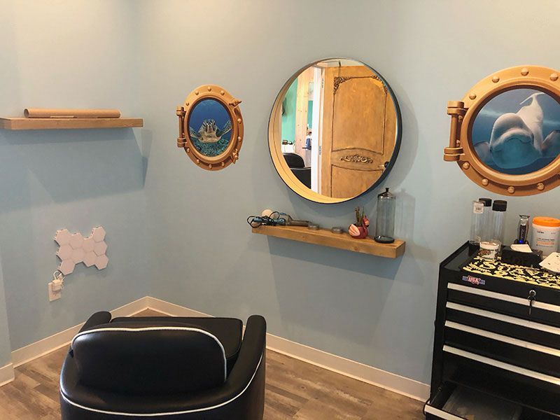 A room with a chair and two mirrors on the wall