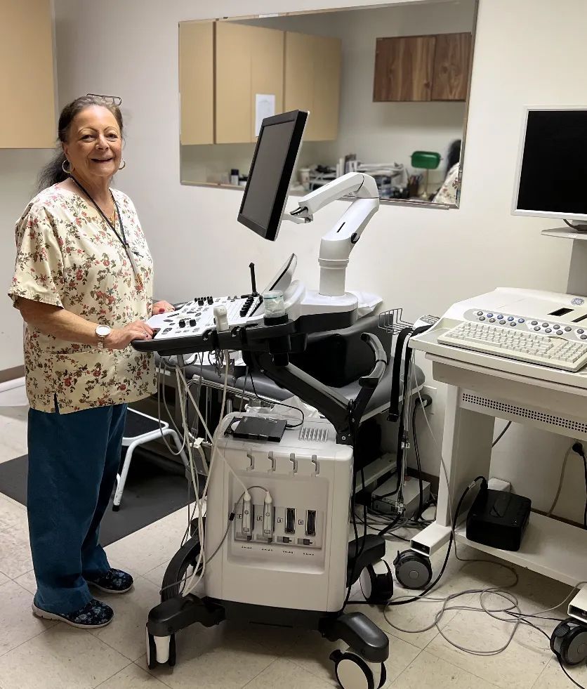 Rose Pompa is standing in front of a medical equipment