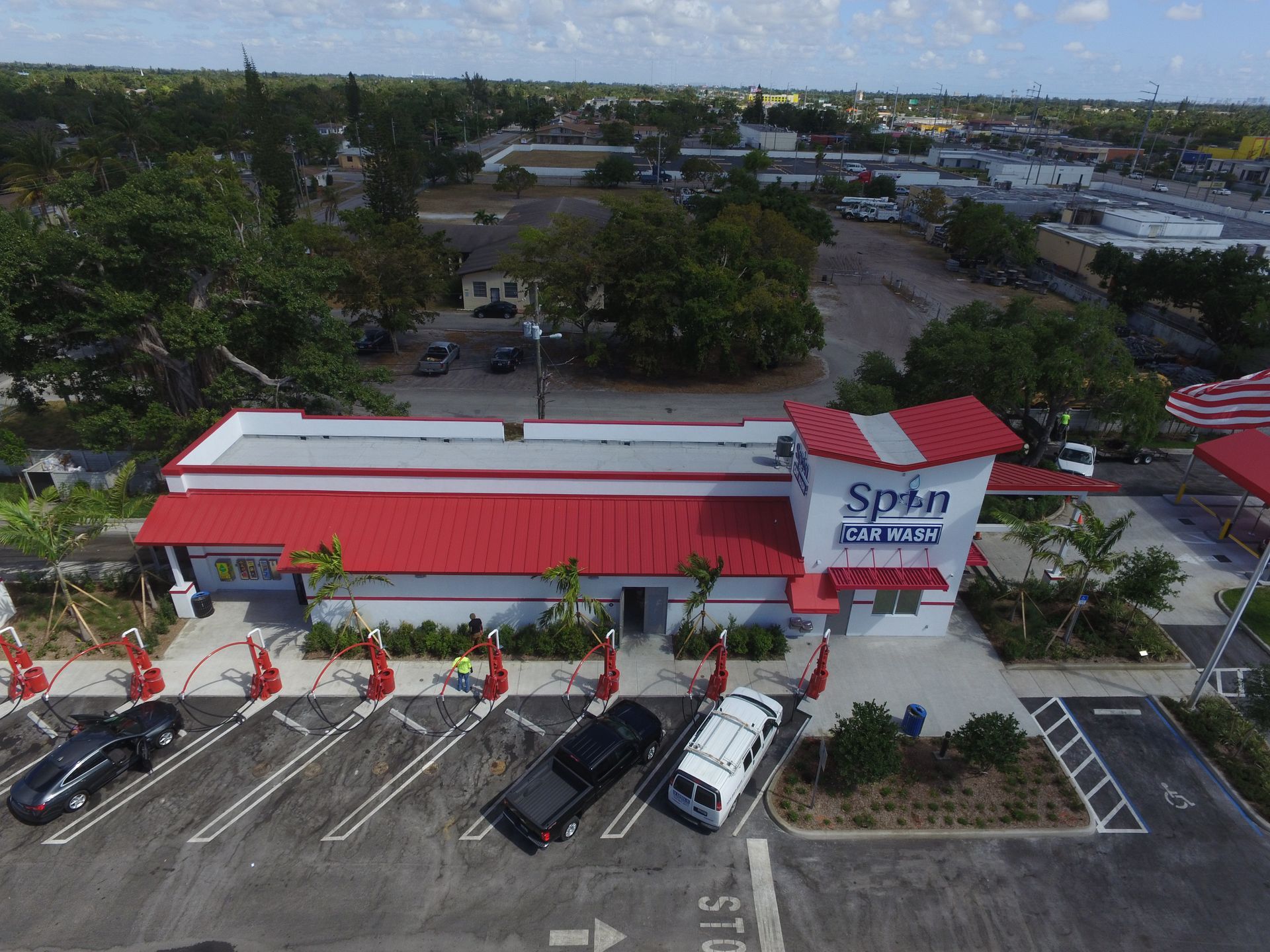 Spin Car Wash, red and white building, cars lined up, sunny day.