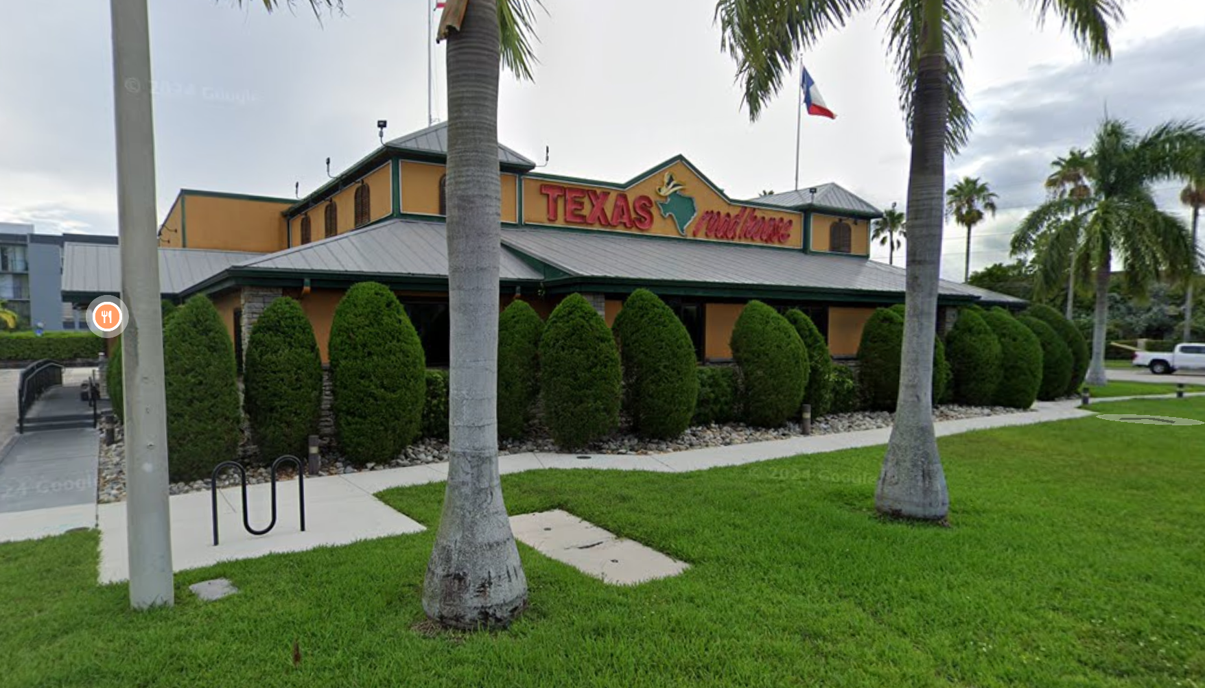 Texas Roadhouse restaurant building with a Texas flag.