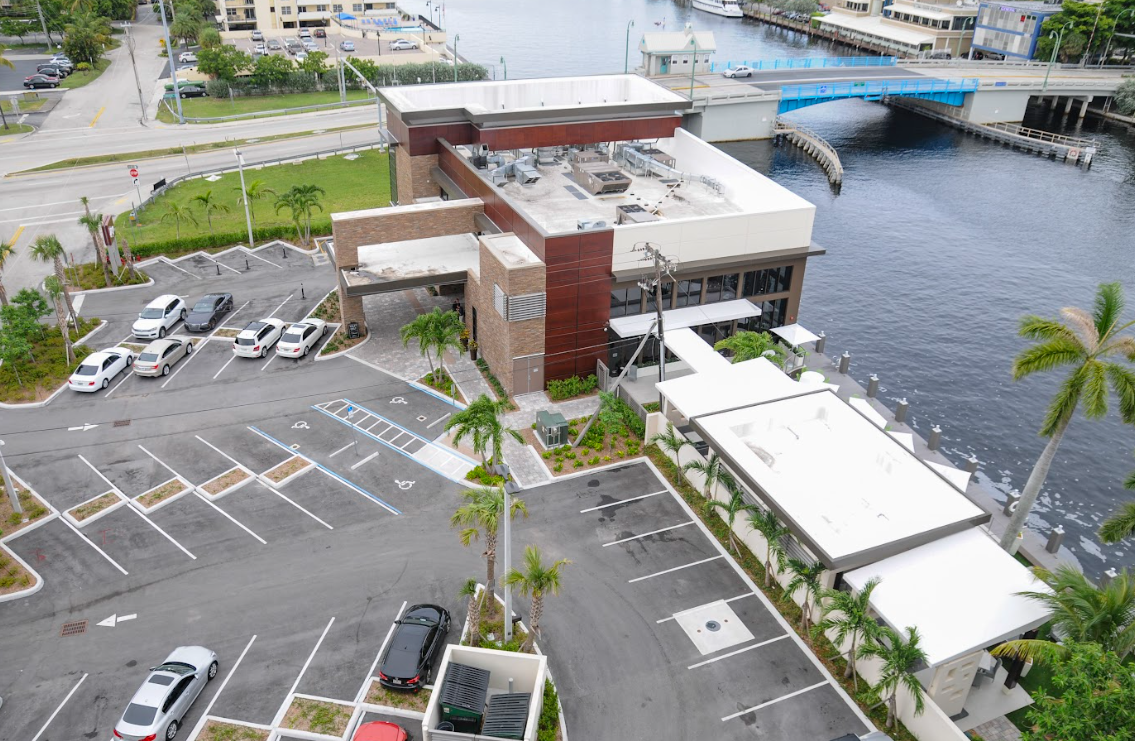 An aerial view of a building with a parking lot in front of it