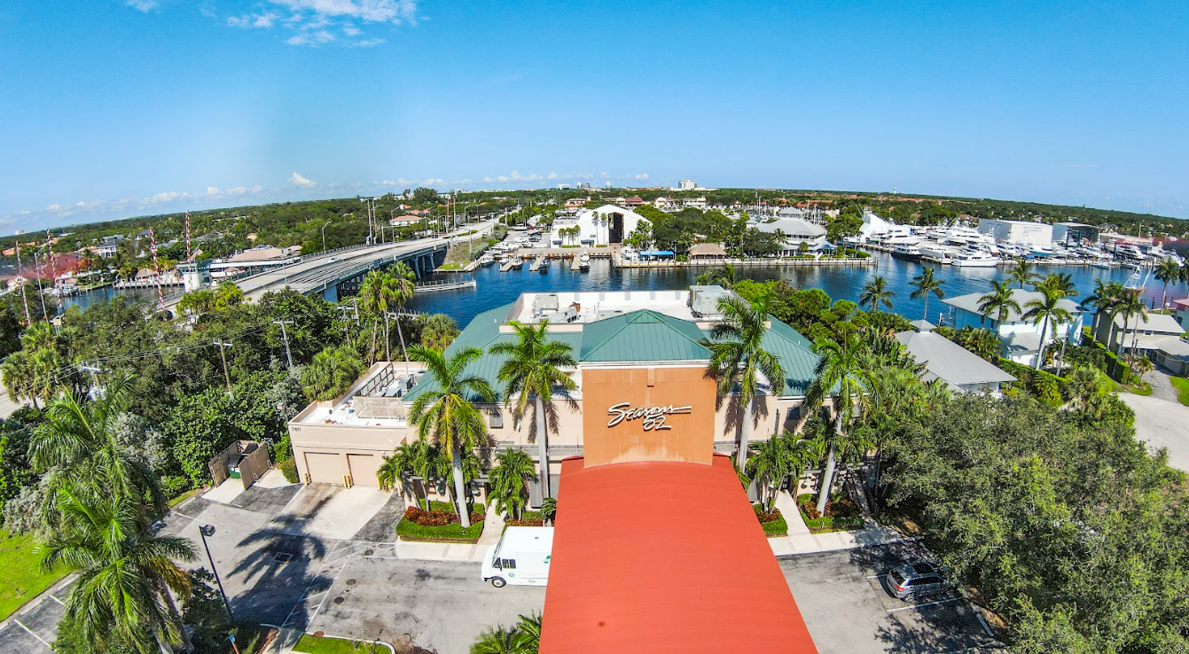 An aerial view of a city with a red roof and palm trees