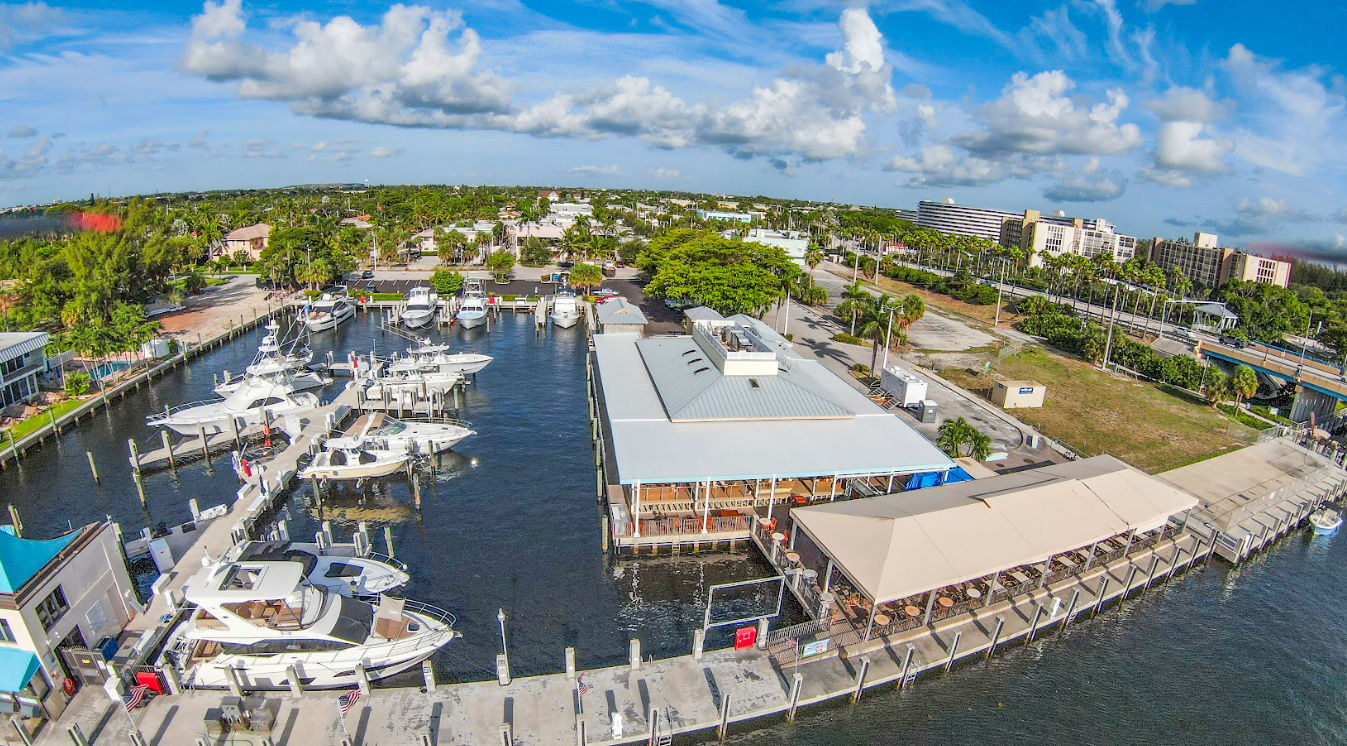 An aerial view of a marina filled with boats and a restaurant