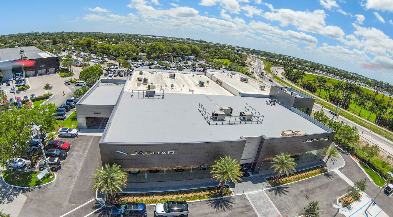 An aerial view of a large building with a parking lot in front of it