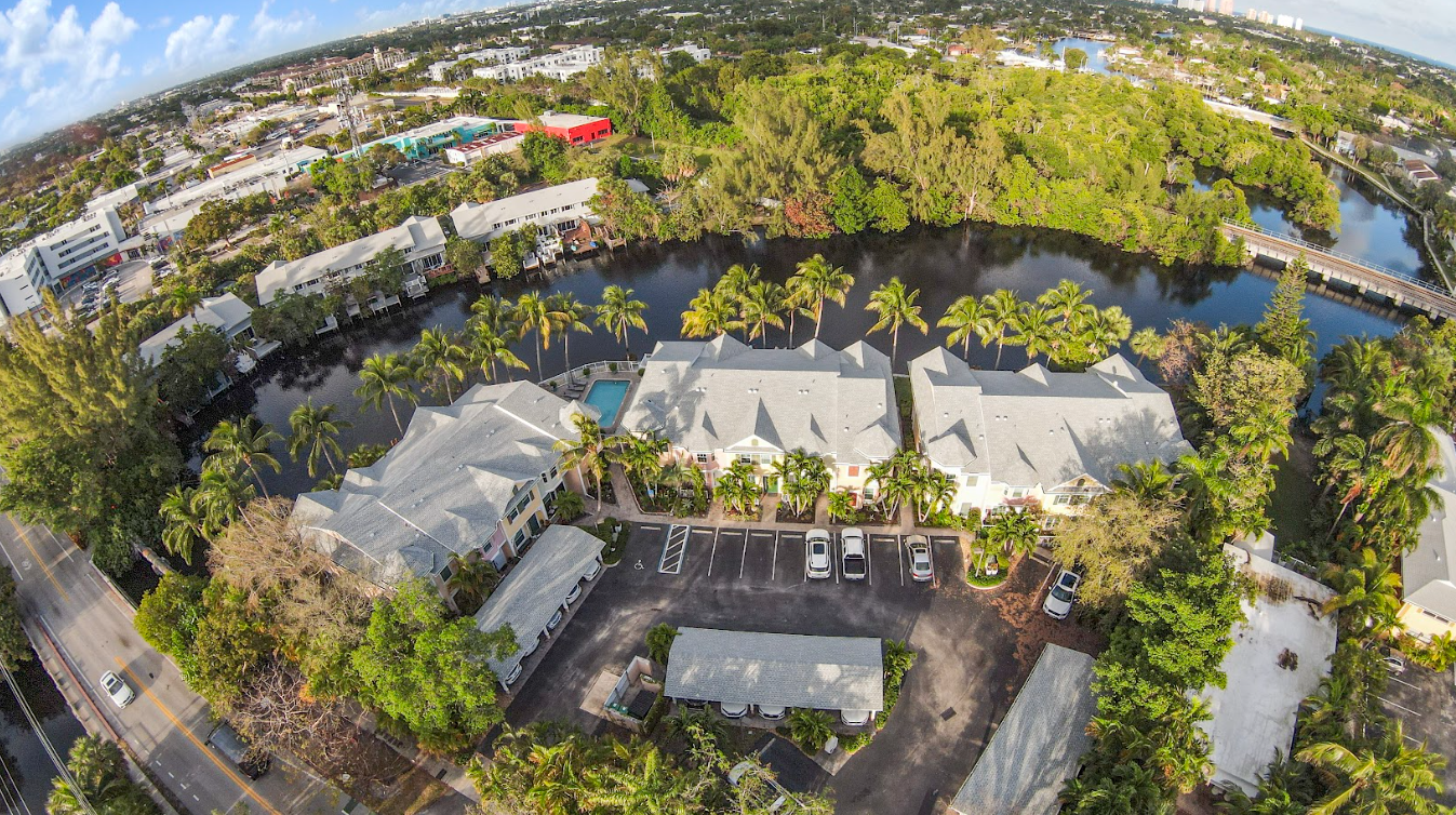 An aerial view of a large body of water surrounded by buildings and trees
