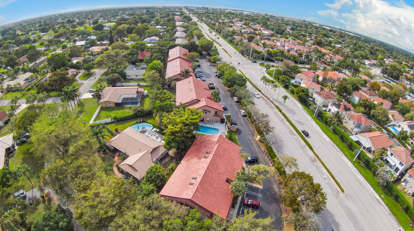 An aerial view of a residential area with houses and a road