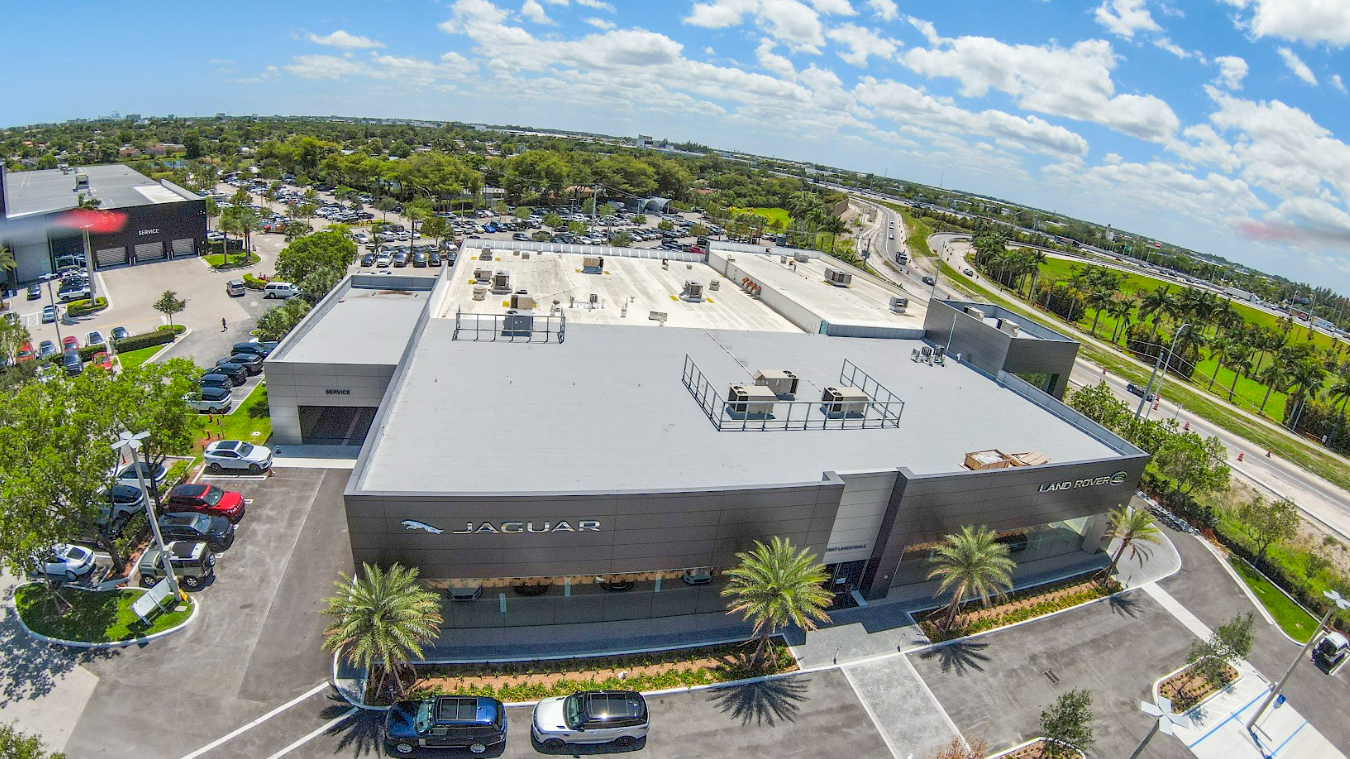 An aerial view of a large building with a parking lot in front of it
