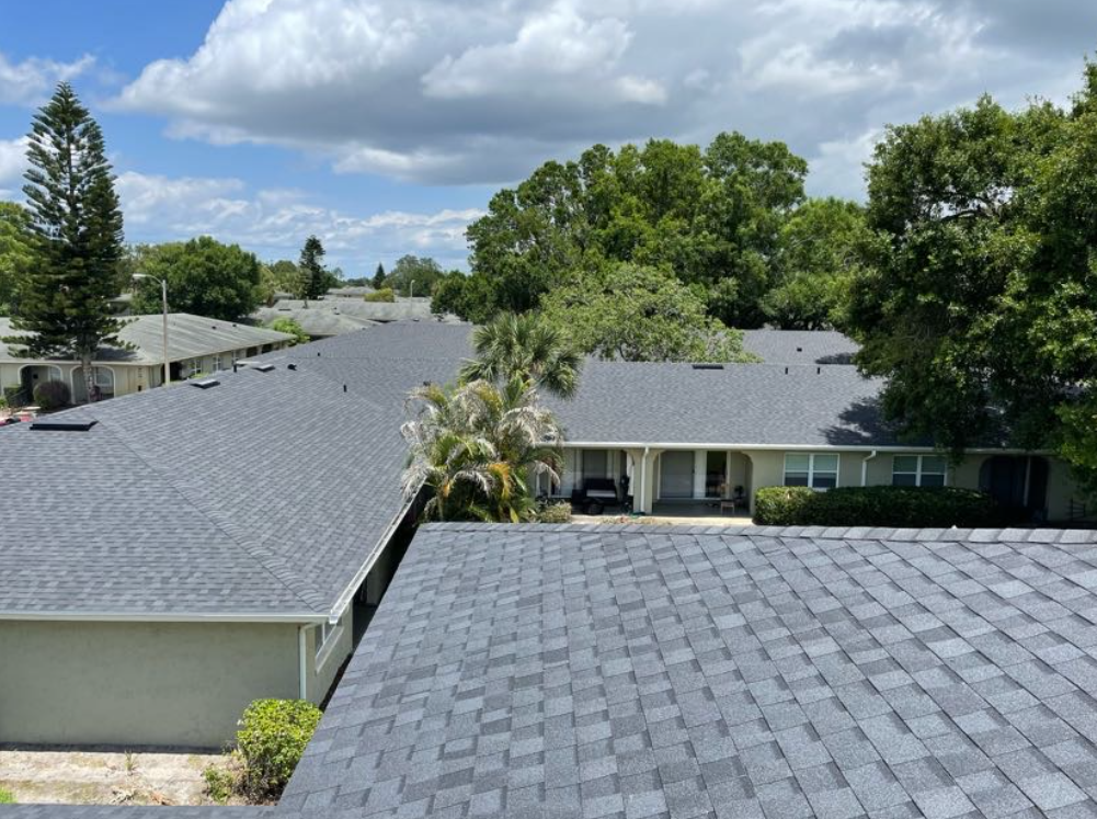 An aerial view of a row of houses with a gray roof