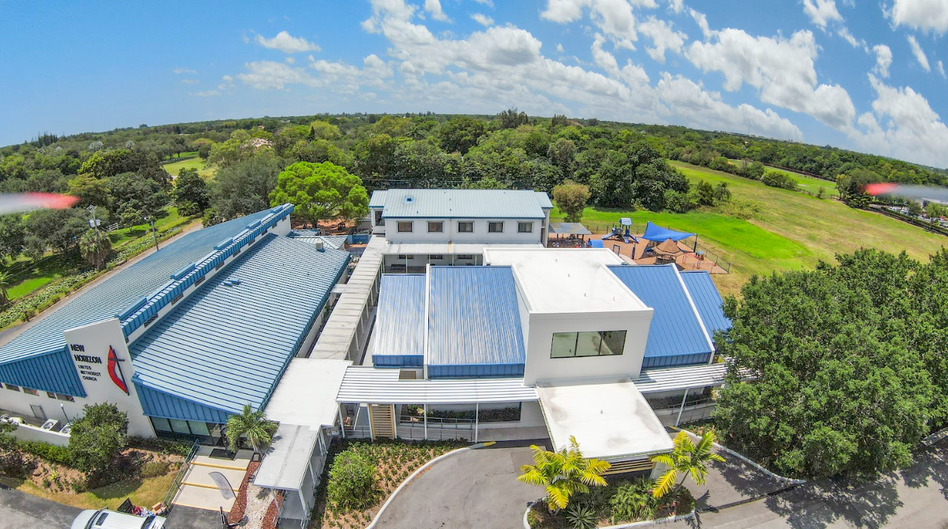 An aerial view of a large building surrounded by trees