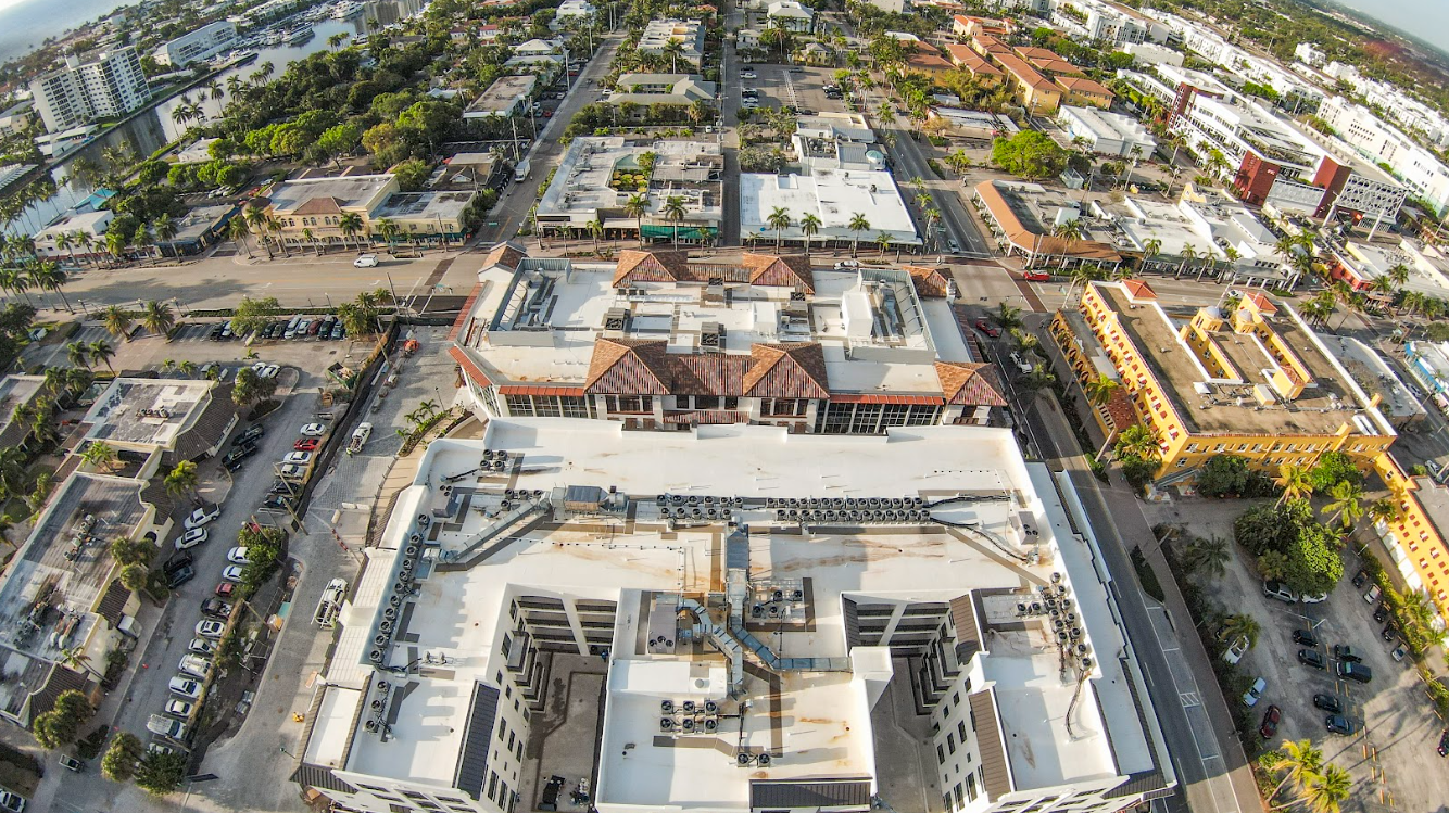 An aerial view of a city with a large building in the middle