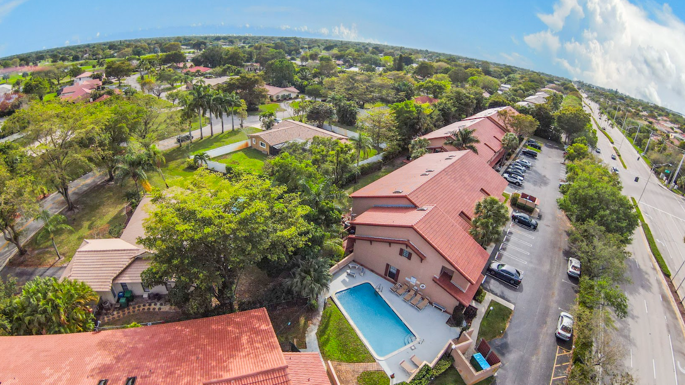 An aerial view of a residential area with a swimming pool