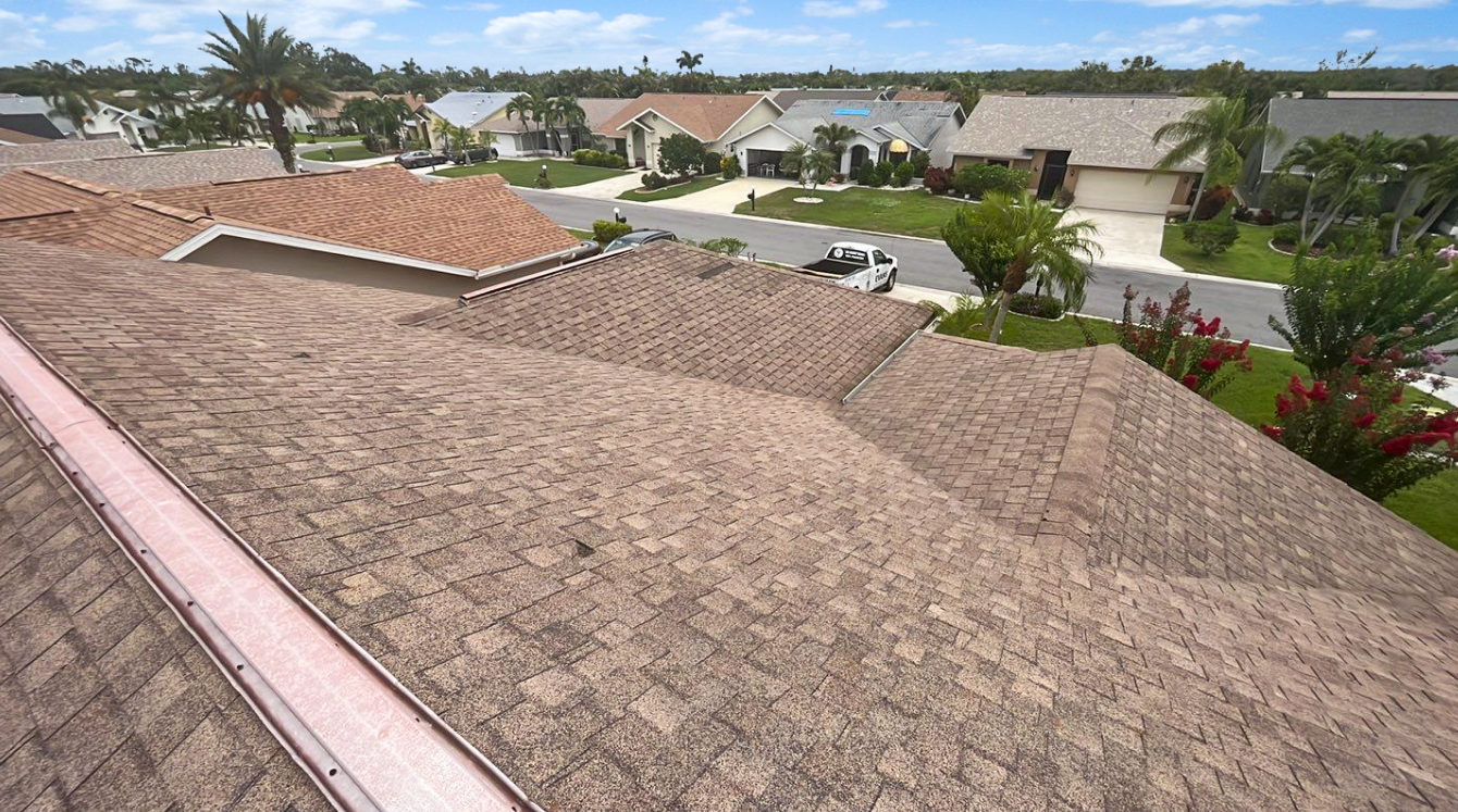 An aerial view of a roof of a house in a residential area