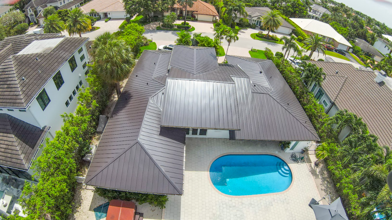 An aerial view of a large house with a swimming pool