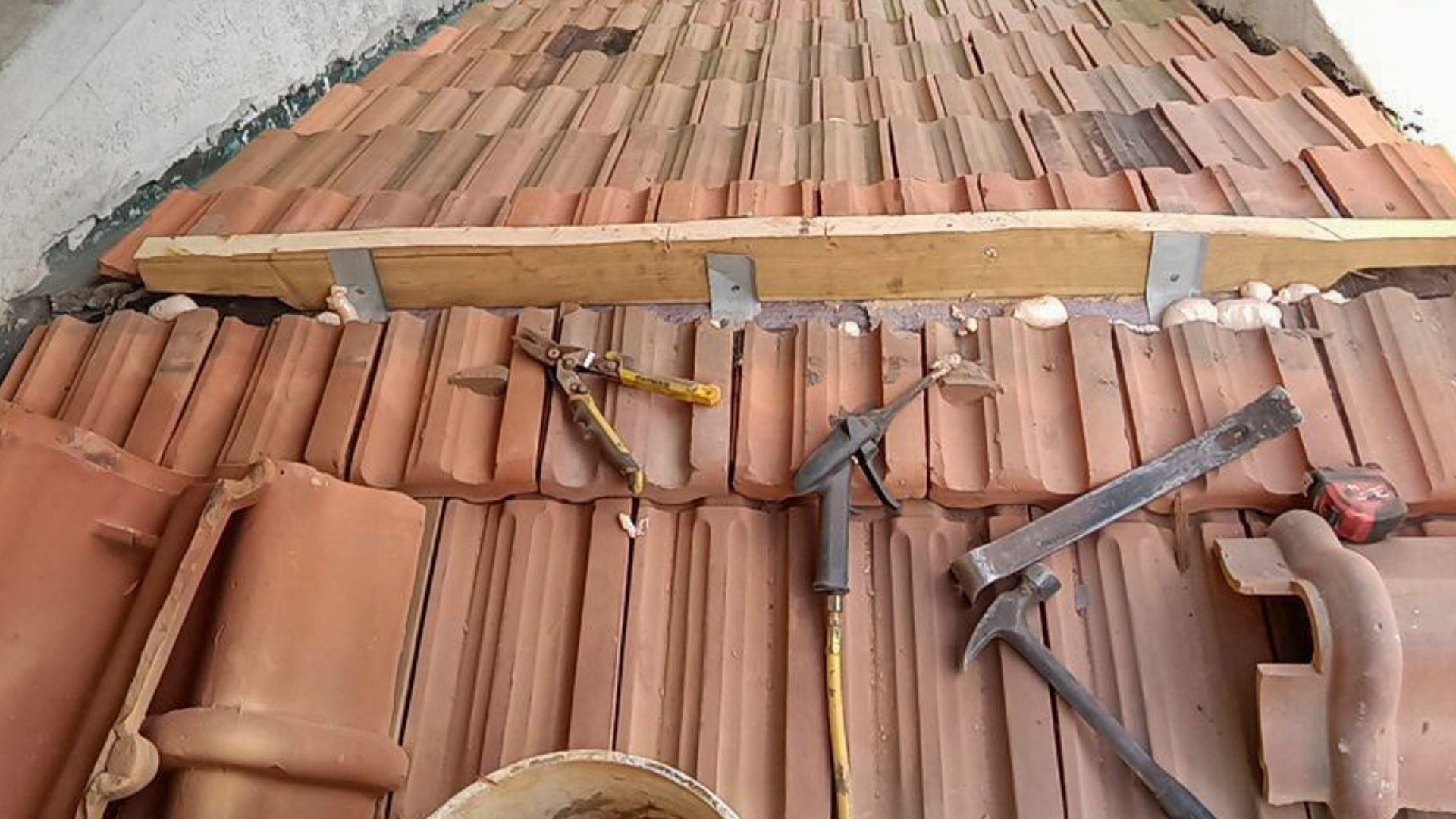 A roof with a lot of tiles and tools on it