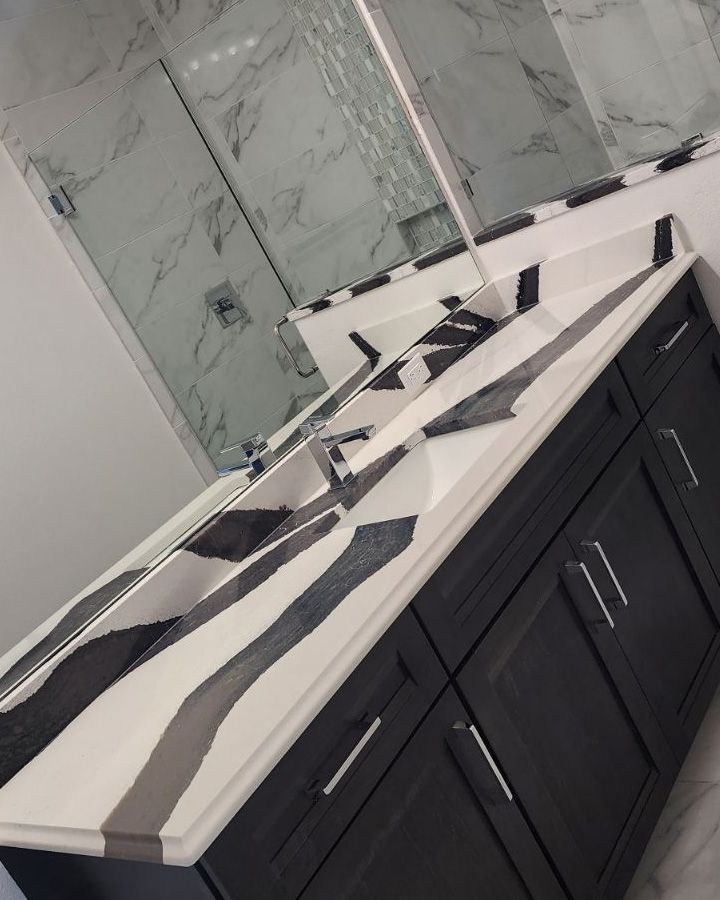 A bathroom with two sinks and a large mirror
