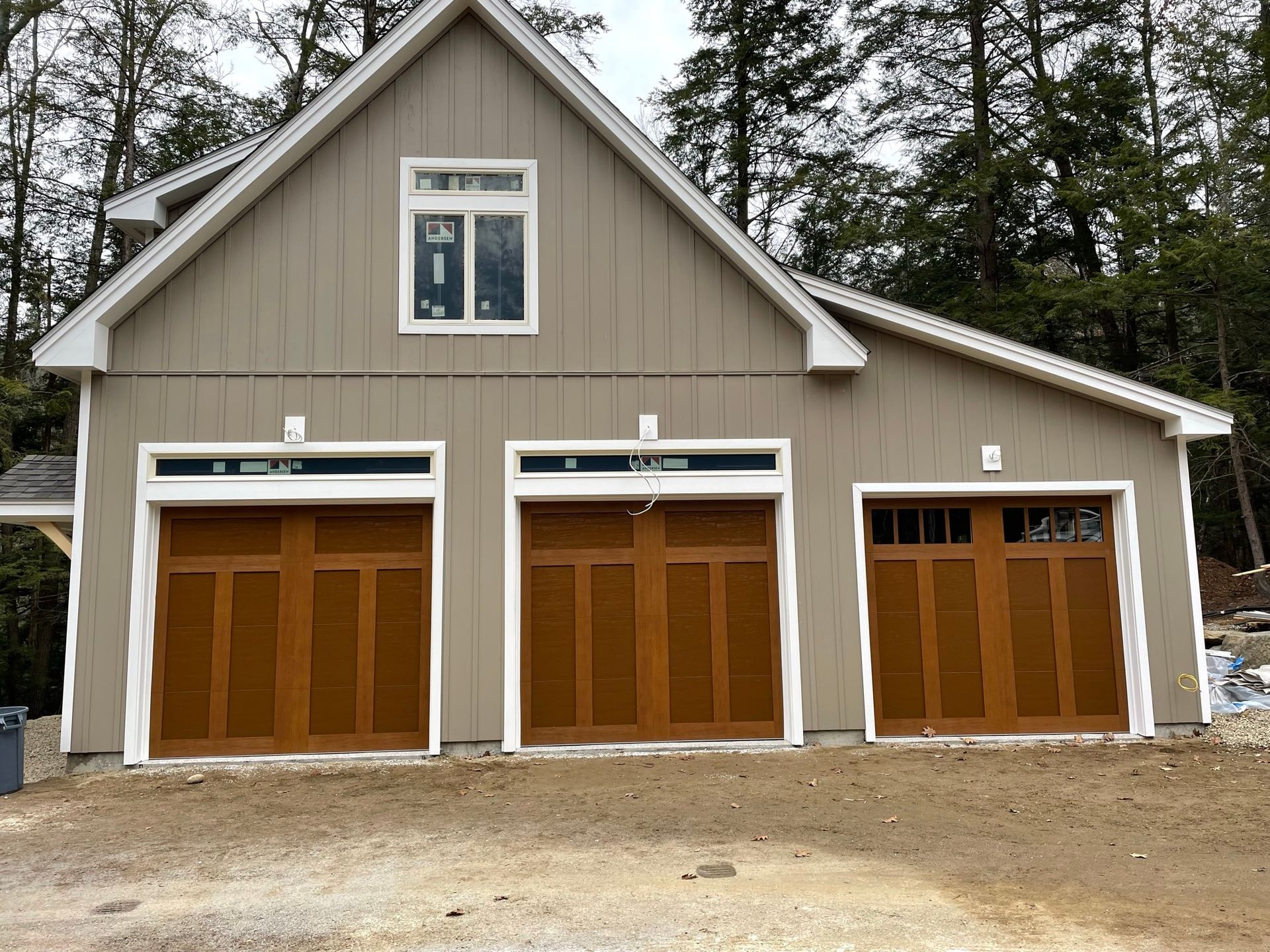 A house with three garage doors and a window