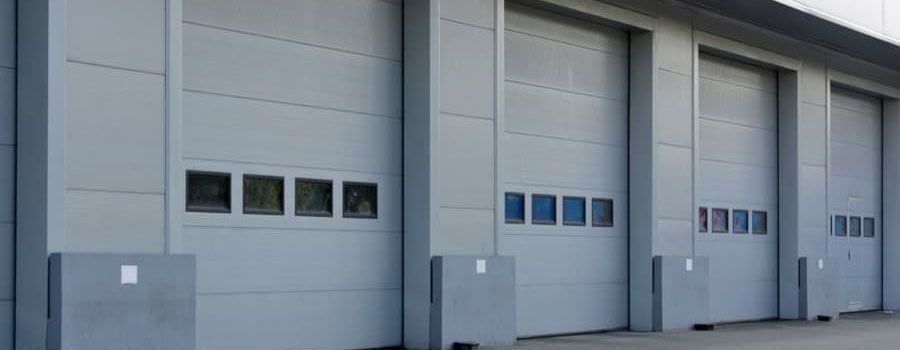A row of garage doors on the side of a building.
