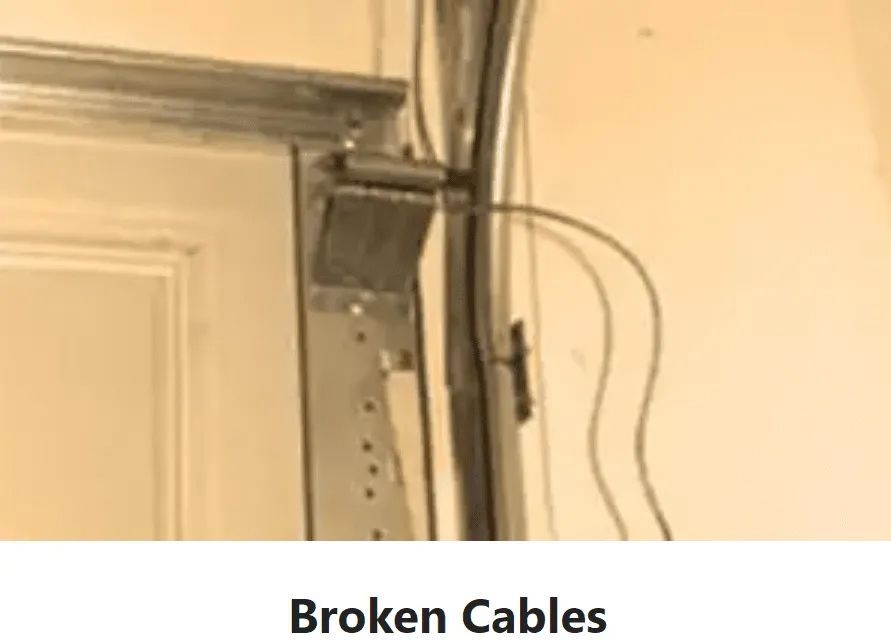A picture of a garage door with broken cables on it.