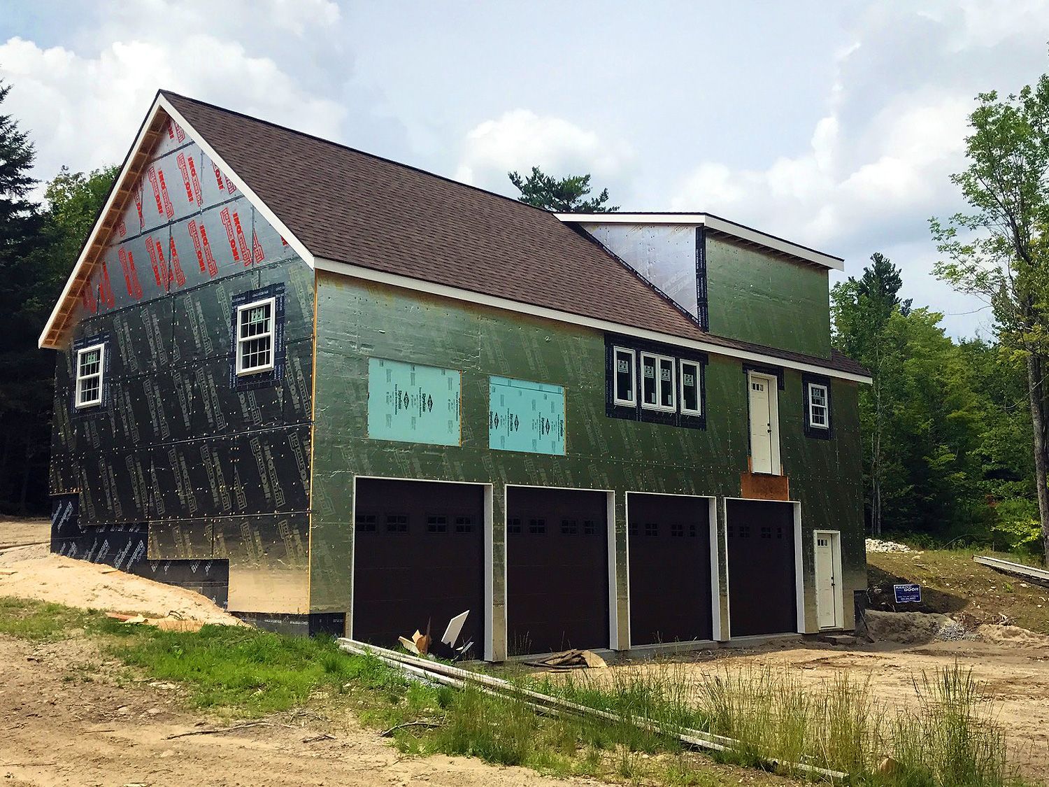 A house is being built in the middle of a dirt field.