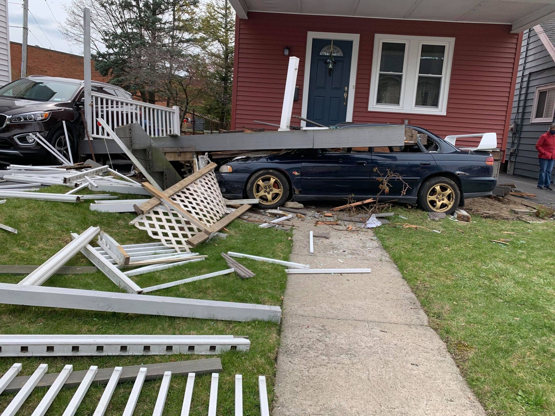 A car that has crashed into a house.
